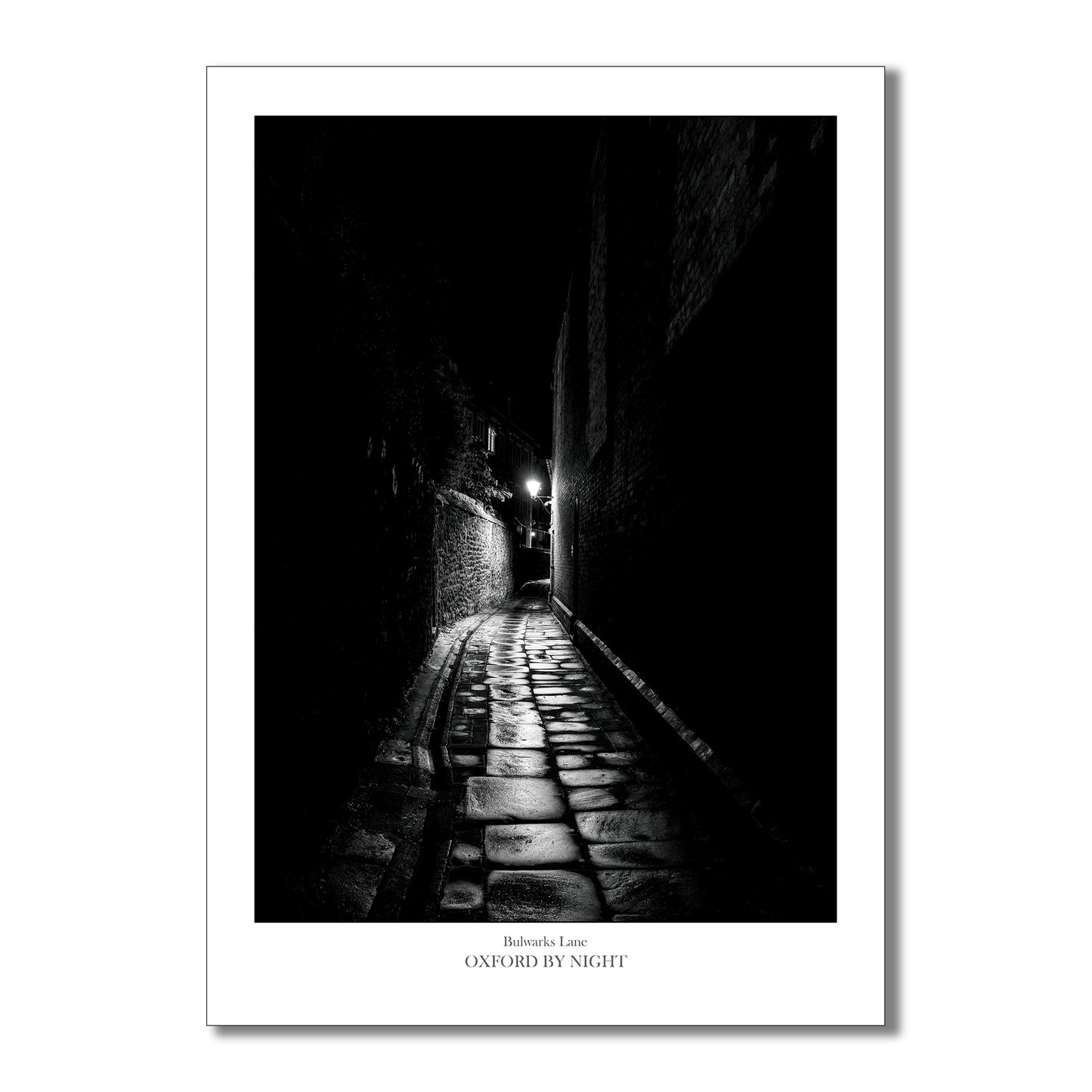 Relive the enchantment of your Oxford visit with this evocative and eerie black and white photographic art print of the narrow cobbles of Bulwarks lane.