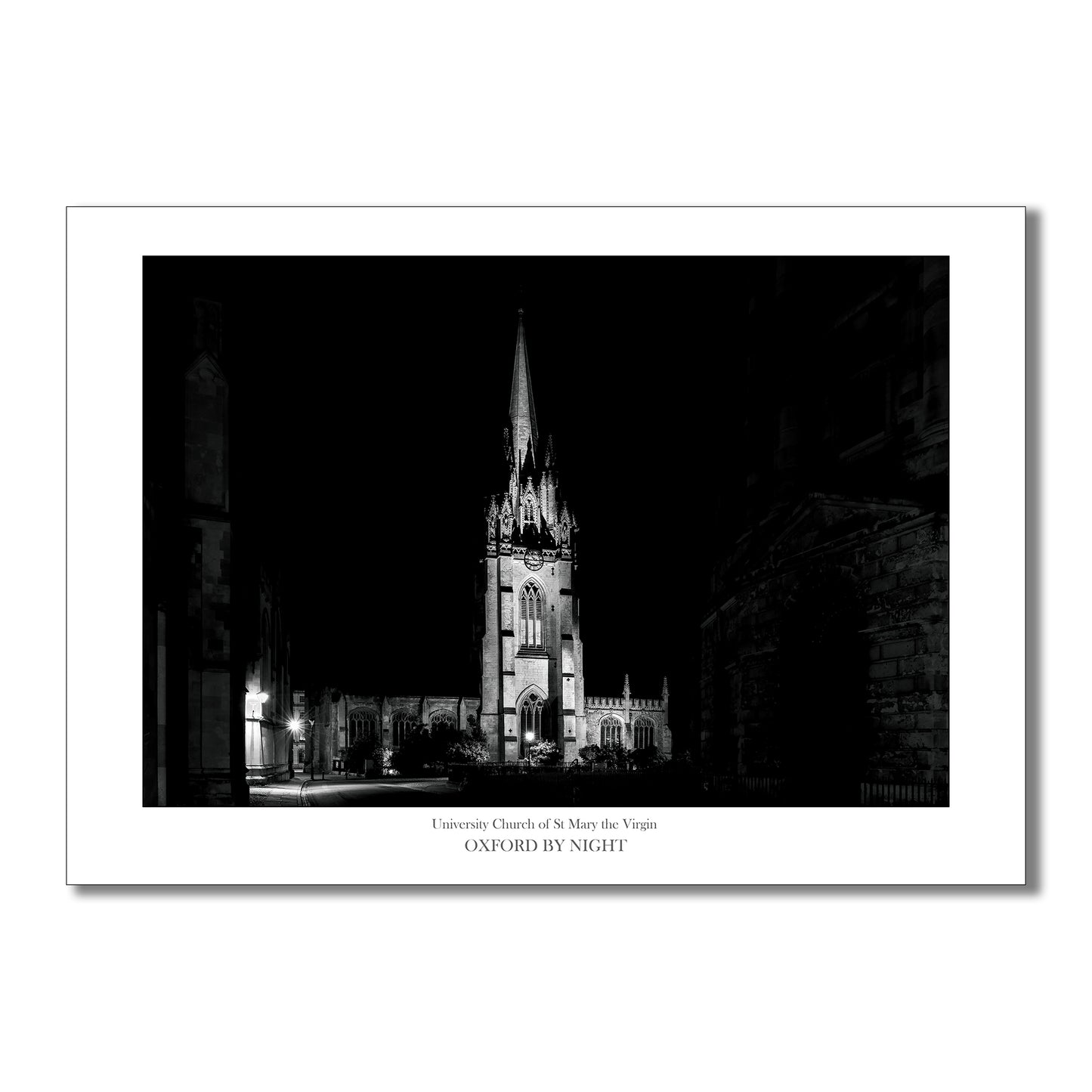 Evocative B&W art print showcasing the floodlit architecture of Oxford University Church under the cover of darkness. A mesmerizing black and white image highlighting the architectural details of this historic building.