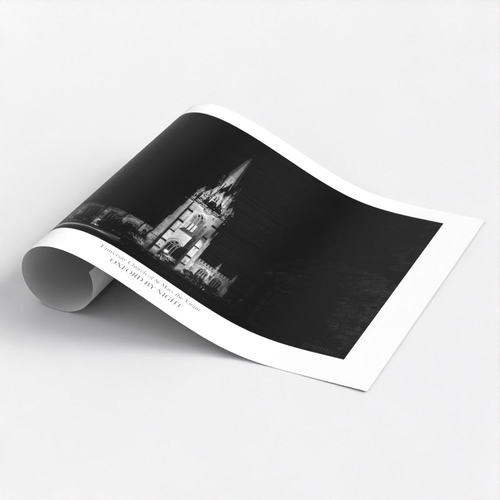 Evocative B&W art poster print showcasing the floodlit architecture of Oxford University Church under the cover of darkness. A mesmerizing black and white image highlighting the architectural details of this historic building.