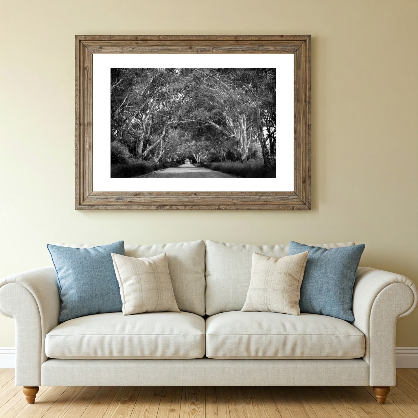 Monochrome wall art print capturing a solitary dirt track under a canopy of gum trees in the Australian outback.